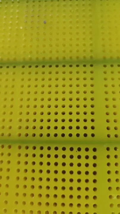 Yellow polyurethane screen panels showing aperture patterns and panel edges