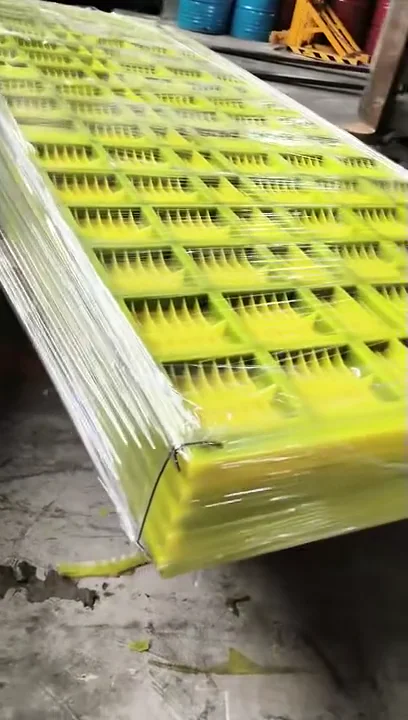 Stacked yellow dewatering screen panels wrapped in clear film for dispatch